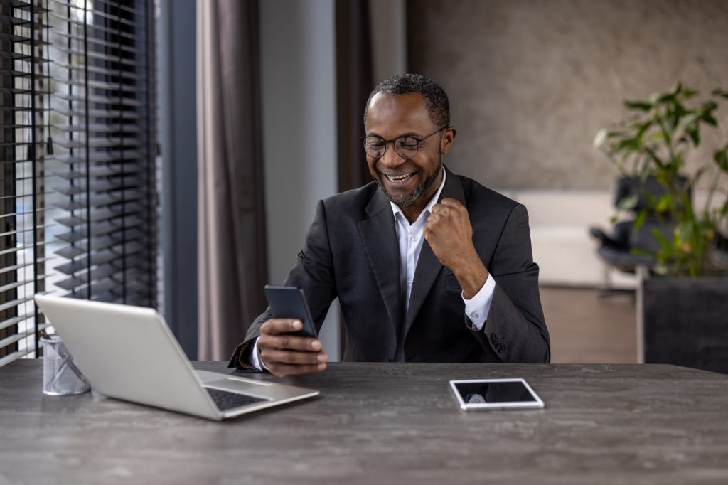 Successful businessman enjoying a victory on a work call