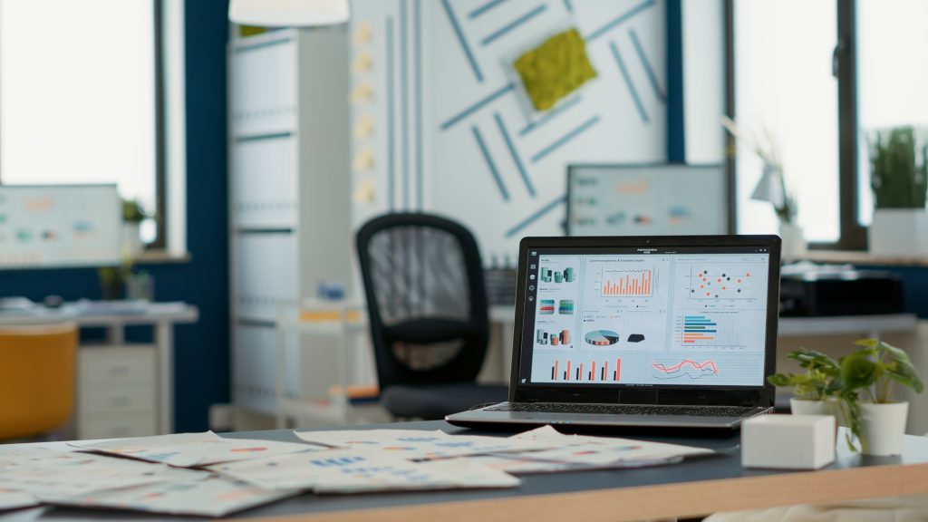 Empty startup office with laptop showing business mangement software on display showing moving
