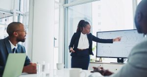 Business, people and presentation with statistics in office on meeting and workshop as accountant.